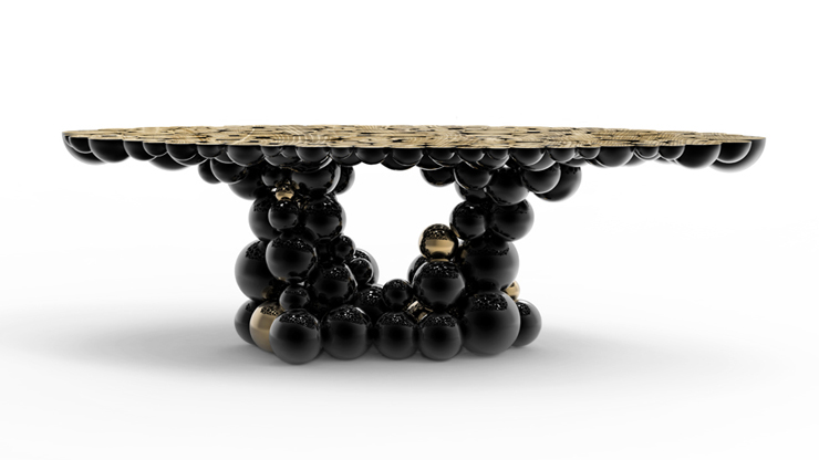 “Una mesa de comedor inspirada en la ley de la gravedad de Isaac Newton, compuesta de esferas y semi esferas brillantes unidas unas encima de otras.”